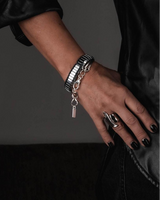 Silver hematite wrap bracelet featuring polished beads, curved metal bars, and an adjustable chain, worn on a model's wrist.