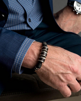 Silver leather men's bracelet featuring dark brown PU leather and strong silver-plated metal accents, worn with a watch.