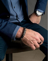 Silver leather men's bracelet featuring dark brown PU leather with silver-plated metal elements, worn on a model's wrist.