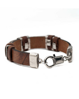 Brown leather bracelet with silver clasps on a white background