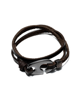 Brown leather bracelet with a metal clasp on a white background