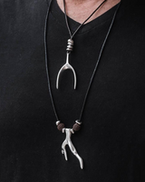 Necklace with a unique pendant on a black shirt