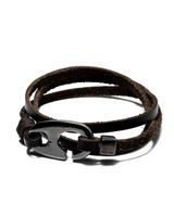 Brown leather bracelet with a black metal clasp on a white background