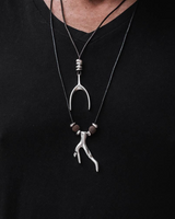 Necklace with a unique pendant on a black shirt