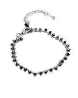 Silver bracelet with black beads on a white background