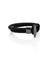 Black rubber band with a metal clip on a white background