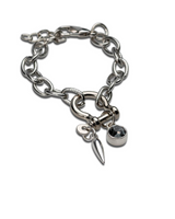 Silver chain bracelet with two charms on a white background