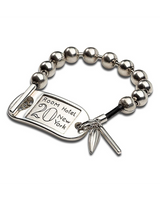 Chunky silver ball chain bracelet features an ID tag with "Room Hotel 20 New York" engraving and a small charm.