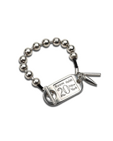 Chunky silver ball chain bracelet featuring a unique ID tag closure with "Room 20" engraving, presented on a black band.