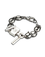 Silver chunky chain bracelet with an ID tag closure and a polished finish, showcasing an edgy design.