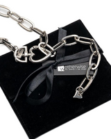 Silver chain necklace with black pendant on a black stand with 'athenwise' branding.