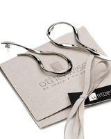Silver scissors on a branded box with 'otherwise' branding.