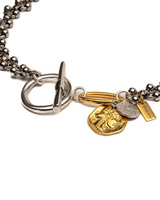 Bracelet with gold and silver charms on a white background