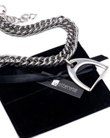 Silver chain necklace with a unique clasp on a black velvet bag with 'otherwise' branding.