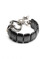 Black beaded bracelet with silver clasp on a white background