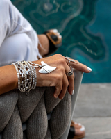 Multi-layer wrap bracelet featuring a silver Great White shark tooth pendant and stacked metal chains.