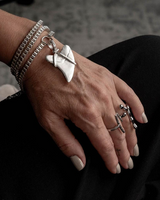 Multi-layer wrap bracelet featuring a silver Great White shark tooth pendant, layered stainless steel chains, and a sleek, edgy style.