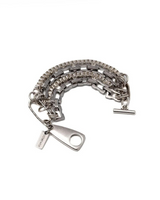 Multi-layer wrap bracelet featuring oxidized silver shark tooth pendant and stacked stainless steel chains.