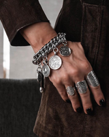 Chunky coin charm bracelet featuring a heavy metal curb chain, antique-style coins, and a genuine leather clasp.