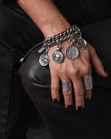 Chunky coin charm bracelet with leather closure, featuring a heavy-duty curb chain and dangling antique-style coins.