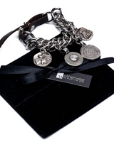 Chunky coin charm bracelet featuring a heavy-duty metal curb chain, leather closure, and dangling antique-style coins.