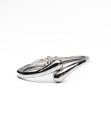 Chunky silver cuff bracelet with a sleek, glossy finish and a minimalistic design, ideal for stacking with other bracelets.
