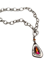 Chunky silver-plated necklace with a red Austrian crystal pendant, featuring an antique-plated steel chain and irregular T-clasp.
