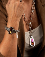 Chunky silver-plated necklace with red Austrian crystal pendant, worn with an adjustable bracelet featuring matching crystal detail.