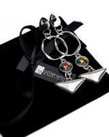 Handmade geometric dangle earrings with vibrant Swarovski crystals, silver plated, featuring abstract shapes and colorful accents.