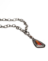 Chunky silver-plated necklace with red Austrian crystal pendant on an antique-plated chain.
