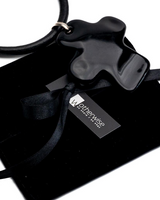 Large black asymmetric cross leather choker necklace featuring an oversized black cross pendant on a thick leather cord.