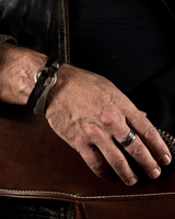 Unisex leather wrap bracelet featuring a silver-plated zamak o-ring, showcasing a cool, edgy style.