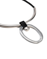 Chunky leather circle pendant choker featuring a silver-plated brass geometric pendant and black leather strap.