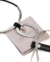 Chunky black leather choker with a large geometric brass pendant, featuring a silver matte finish. Comes with a suede pouch.