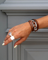 Triple wrap genuine leather bracelet with sterling silver accent, styled on a model's wrist with a chunky silver ring.
