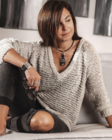 Wide leather cuff bracelet featuring black leather and silver-plated Zamak bars, worn on a woman's wrist.