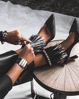 Wide black leather cuff bracelet worn on the wrist, featuring silver-plated Zamak bars and mixed chain strands.