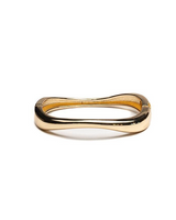 Chunky gold cuff bracelet with a smooth, polished finish and a hollow design, suitable for small to medium wrists.