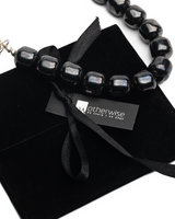 Hematite leather choker set featuring a silver hematite beaded choker, gunmetal leather choker, and black leather choker.