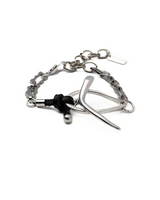 Silver curb bracelet featuring a T-clasp, stainless steel chain, and a unique curved design with a black leather accent.