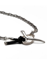 Silver curb statement jewelry set featuring a stainless steel chain, silver plated elements, and a black leather accent.