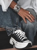Chunky statement bracelet in antique silver with zamak slider bars and flat brass chain, worn snugly on the wrist.