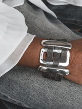 Chunky statement bracelet with large zamak slider bars and flat brass chain, antique silver plated, worn on wrist.