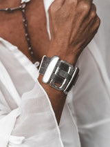 Chunky statement bracelet with large zamak slider bars and flat brass chain, antique silver plated, worn on a wrist.