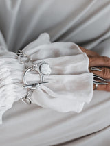 Silver Phaistos Disc Bracelet with an asymmetric link chain and large toggle closure, featuring a teardrop pendant.
