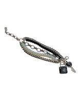 Five-strand bracelet featuring gray moonstone, black glass beads, and a lock and key pendant, crafted from durable stainless steel.