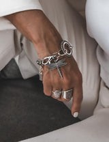 Sterling silver bracelet featuring a large, detailed dragonfly pendant on a chunky stainless steel link chain.