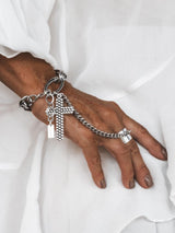 Stainless steel cross hand chain bracelet featuring a large cross pendant and an antique silver-plated ring.