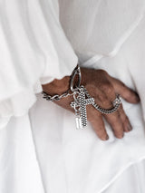 Gothic cross hand harness bracelet in tarnish-resistant stainless steel, featuring a large cross pendant and an adjustable ring.