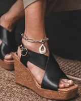 Stainless Steel Teardrop Anklet displayed on an ankle, featuring a large smooth teardrop pendant and a wavy oval link chain.